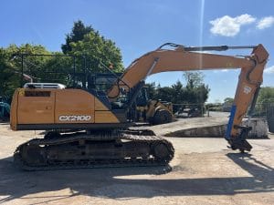 CX210D excavator with a long arm and tracks, positioned on a construction site.